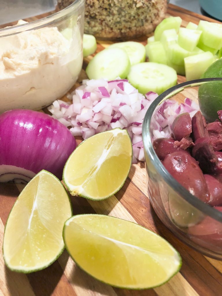 Ingredients for the Greek Quinoa Salad: lime, red onion, kalamata olives, cucumbers, quinoa