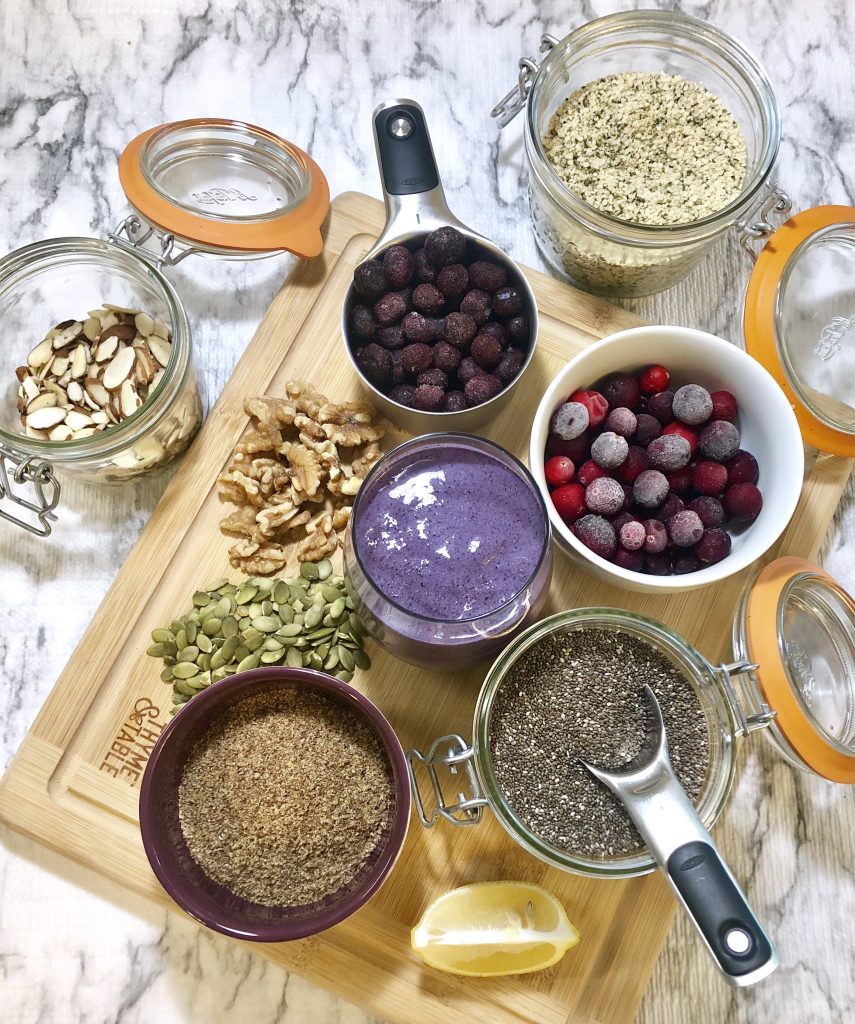 Hyman Inspired Superfood Shake Ingredients spread across the counter and cutting board