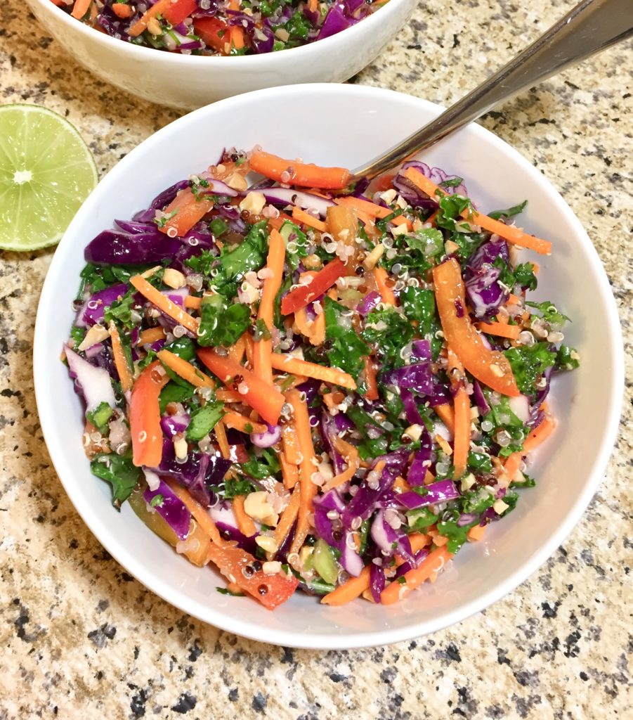 Colorful bowl of Cruncy Thai Quinoa Salad with a lime beside it
