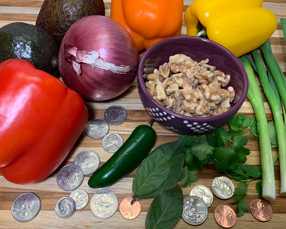 Vegetables, nuts, herbs, and coins on a cutting board