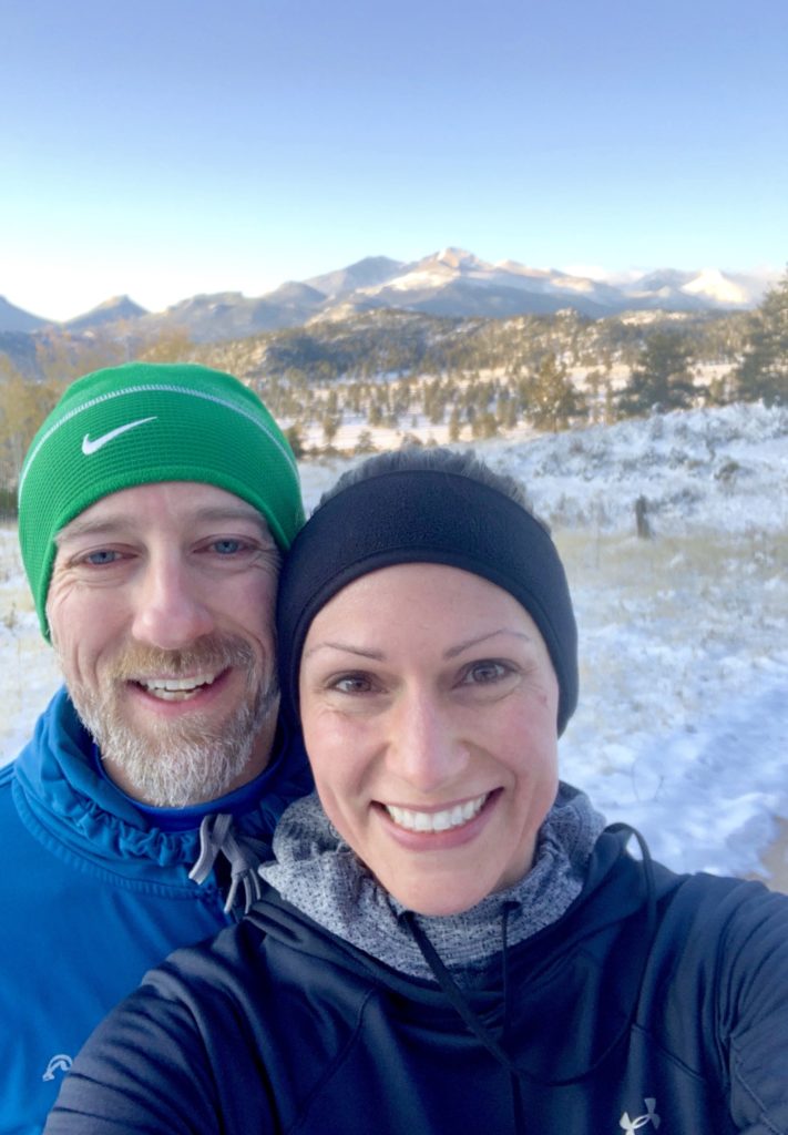 How much does exercise impact our mental health? Paul and I on Lumpy Ridge Trail in Estes Park with snow on the ground and mountains in the back. 